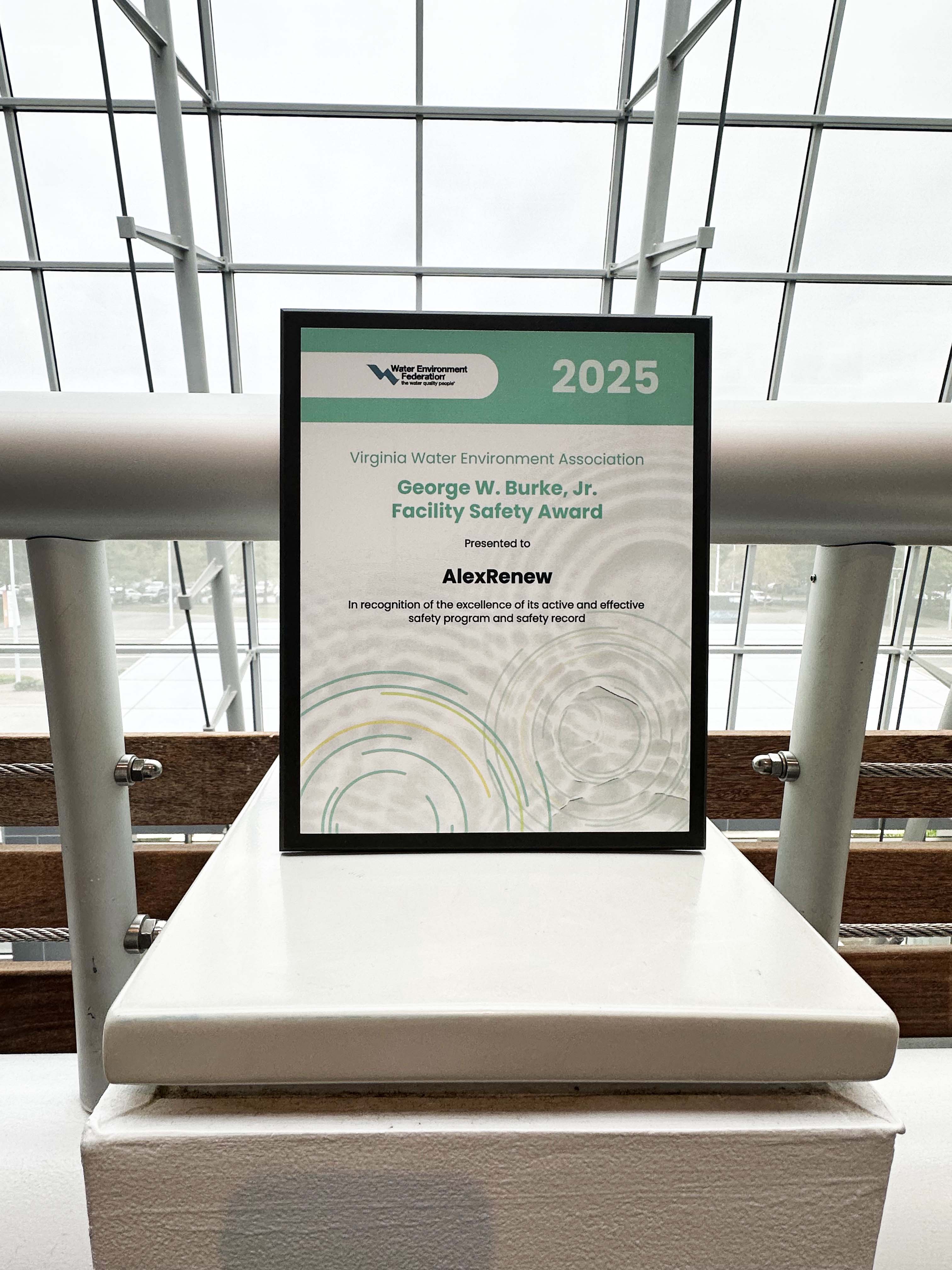 Photo of the 2025 George Burke Award certificate with a large window in the background.