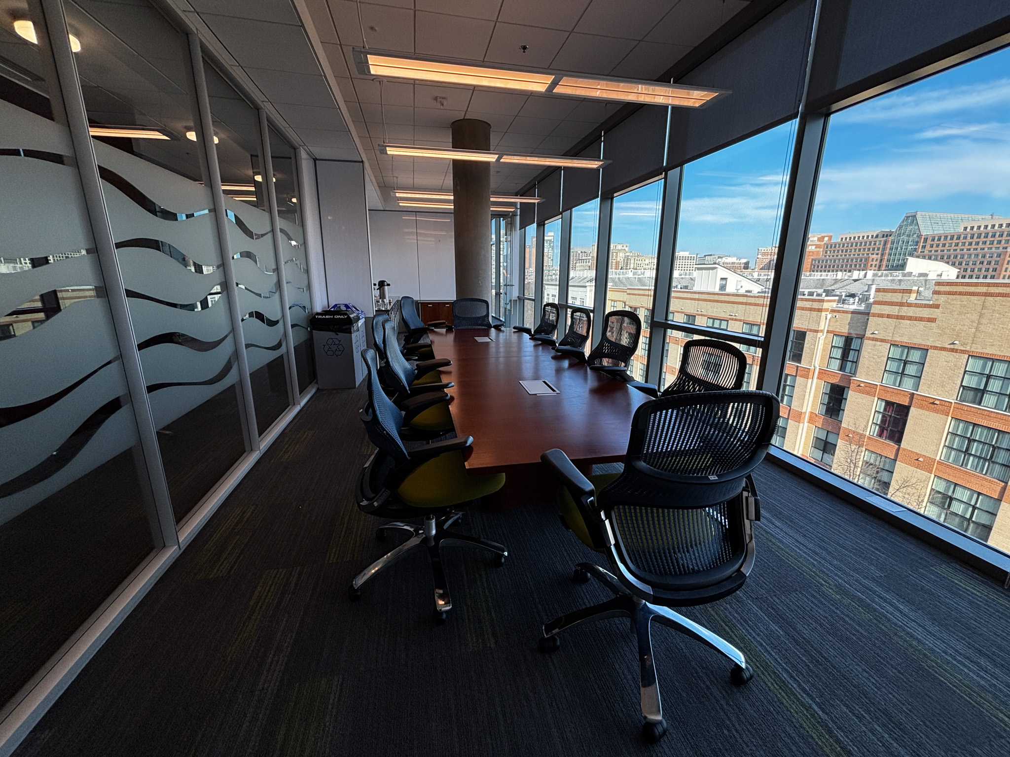 small conference room space with large windows on the right looking over Alexandria.