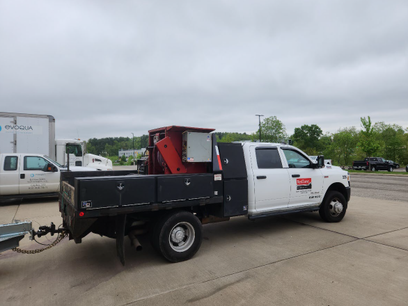 A truck with a large red cable