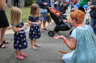 Moxie with Children at Earth Day